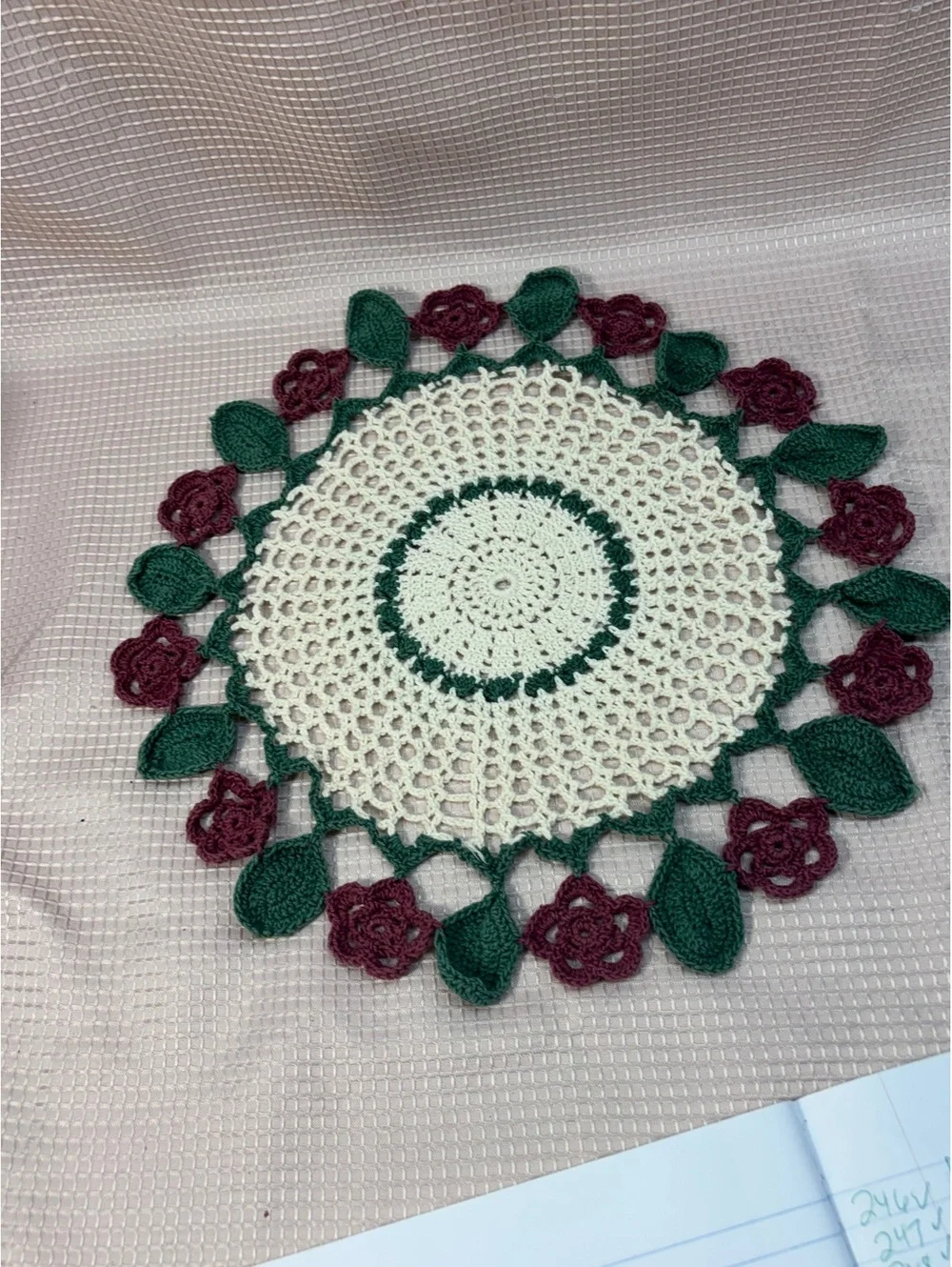 vintage crocheted doily centerpiece featuring a cream, maroon rose & dark green